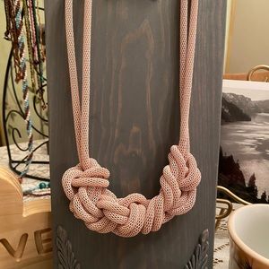 Urban Outfitters pale pink mesh chain knitted necklace. Clip earrings are sold.